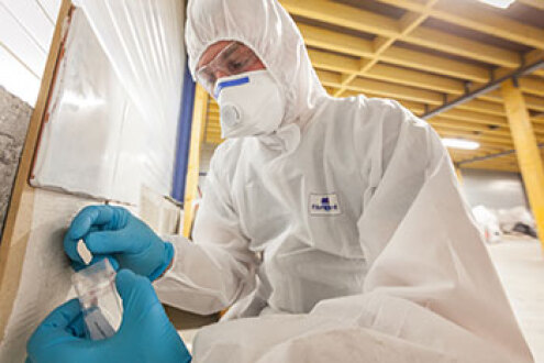 Surveyor taking samples during home buyers asbestos survey