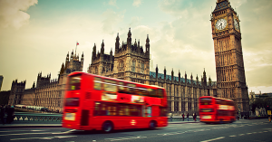 Two red London buses drive past the Palace of Westminster and Big Ben, SAM Conveyancing discuss the London Housing Market Two red London buses drive past the Palace of Westminster and Big Ben, SAM Conveyancing discuss the London Housing Market