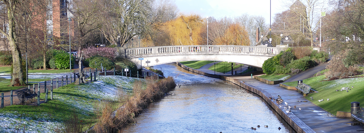 Victoria Park in Stafford, Staffordshire, Midlands, England, showing a white iron bridge over a canal. SAM Conveyancing's Staffordshire property market report, based on the latest data from the Land Registry.