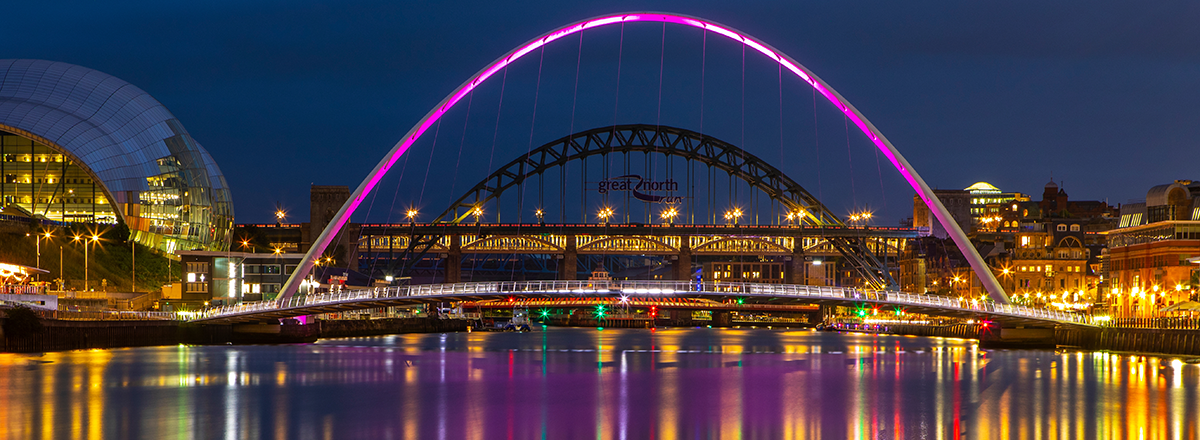 A view over the River Tyne, featuring the Gateshead Millennium Bridge and Tyne Bridge in Newcastle, Tyne and Wear. SAM Conveyancing analyses the latest Land Registry Data in our Tyne and Wear housing market report.